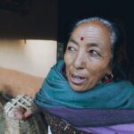 an elderly woman with bindi on her forehead