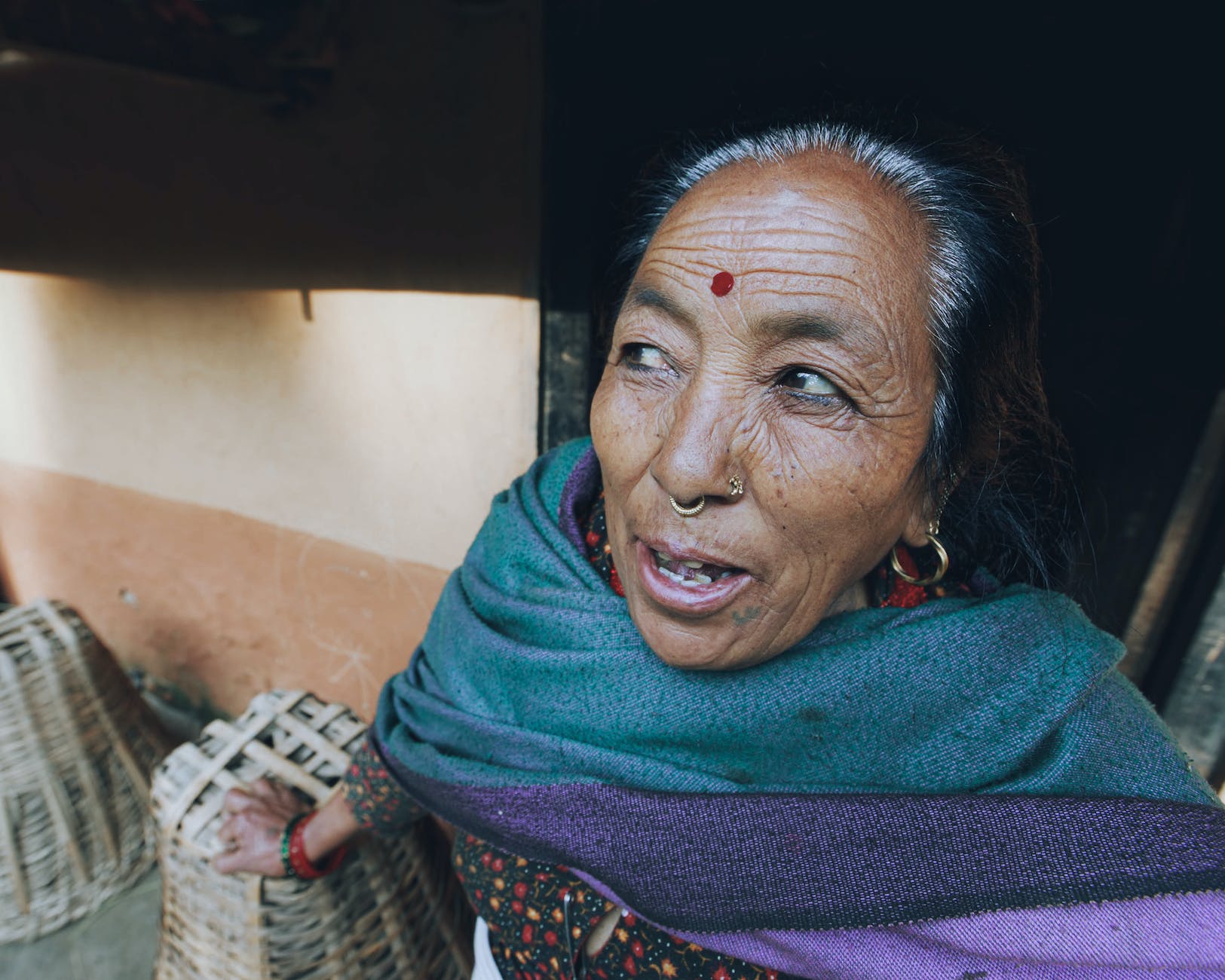 an elderly woman with bindi on her forehead
