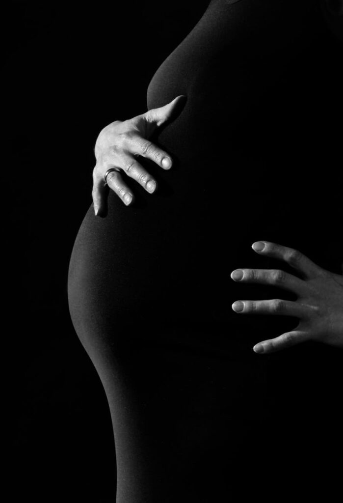 gray scale photo of a pregnant woman